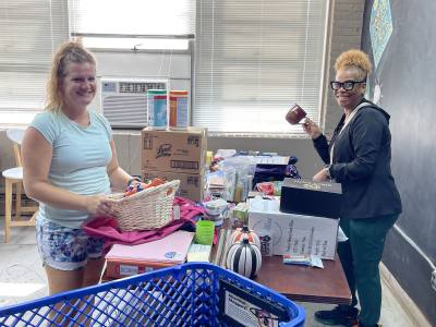 Two people helping with the move to the Food Bank