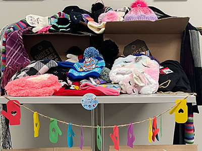 volunteer winter accessories display for a donation drive