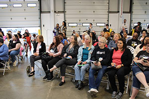 A seated group of people attending a meeting at SC4K