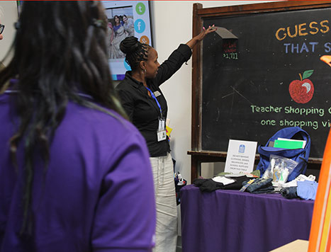 teacher with blackboard at a shop event