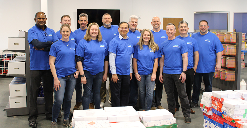 Group of Lubrizol Employees in blue shirts standing in SC4K Free Store